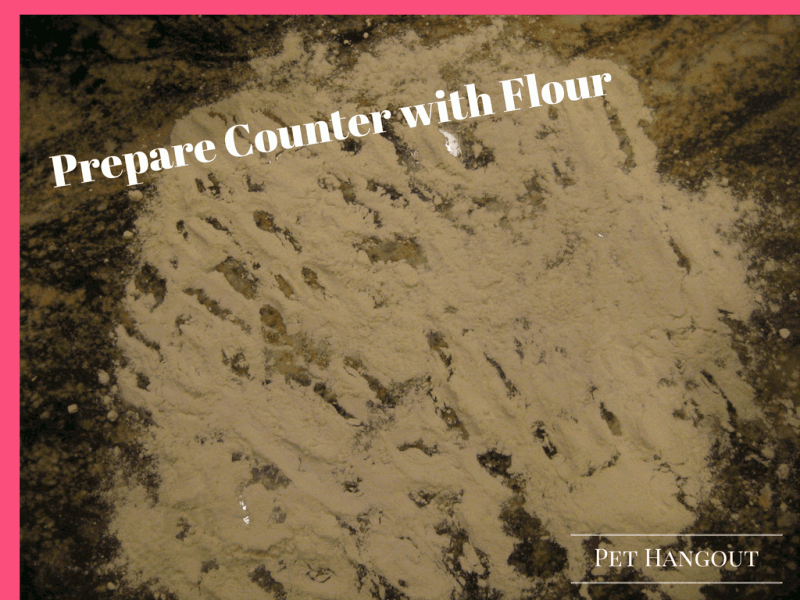 Prepare counter with flour